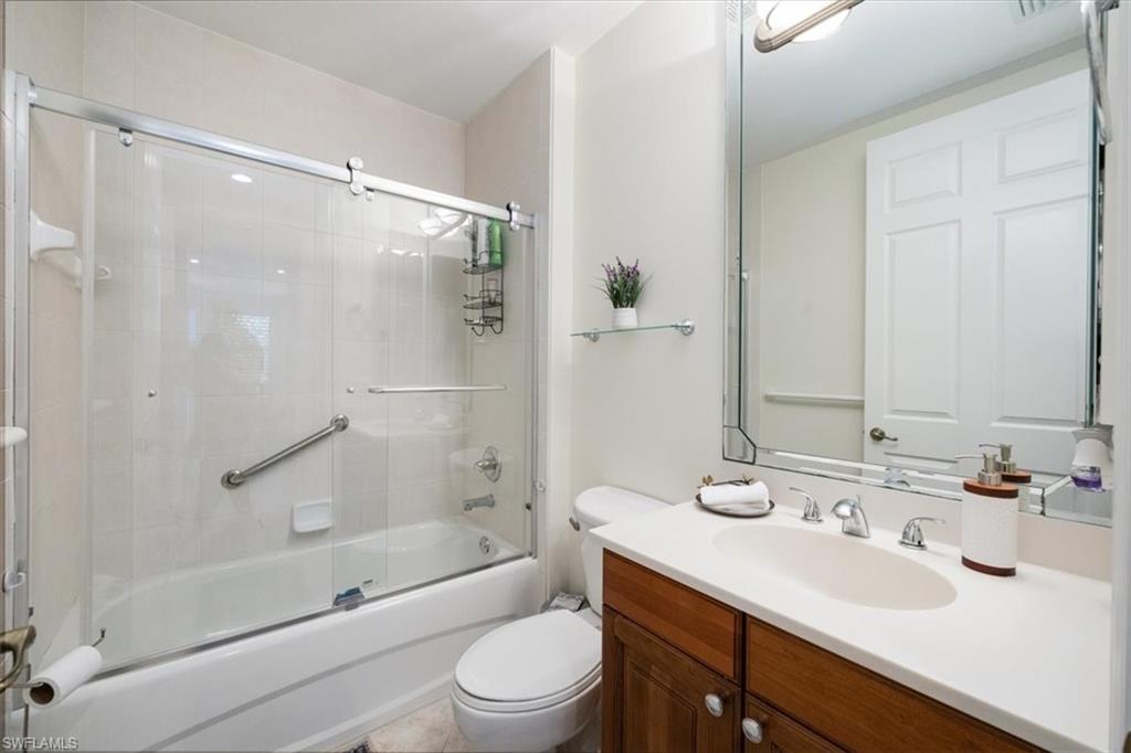 730 Regency Reserve Circle, Unit 2802 Naples, FL 34119 - Photo 12 of 22 a bathroom with a sink mirror toilet and bathtub