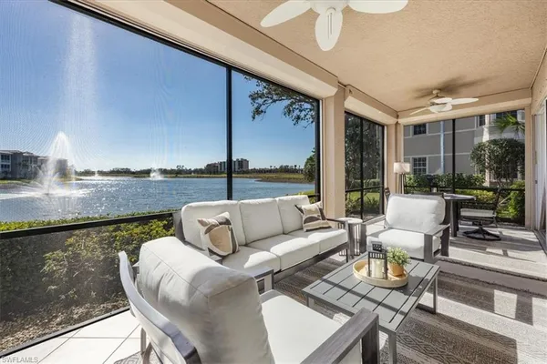 a balcony with furniture and a floor to ceiling window