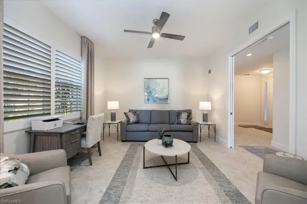 a living room with furniture and a large window
