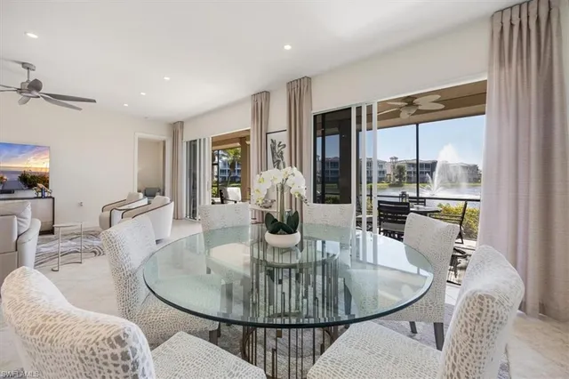 a dining room with furniture a chandelier and wooden floor