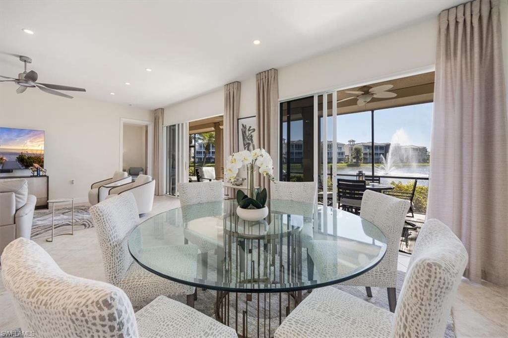 730 Regency Reserve Circle, Unit 2802 Naples, FL 34119 - Photo 7 of 22 a dining room with furniture a chandelier and wooden floor