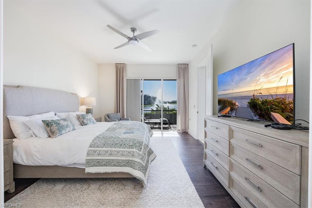 730 Regency Reserve Circle, Unit 2802 Naples, FL 34119 - Photo 9 of 22 a bedroom with a large bed and a flat screen tv