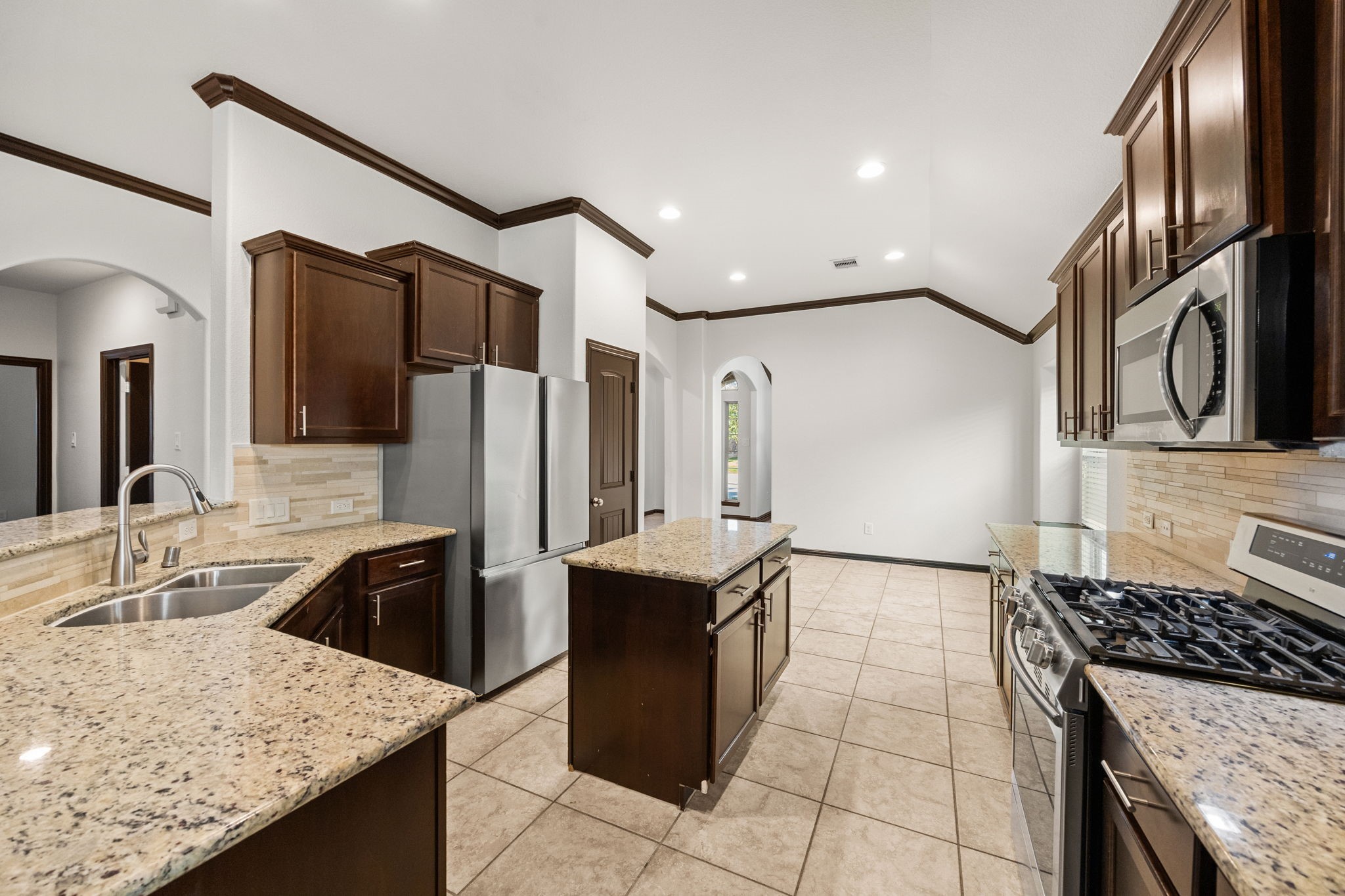 4342 Ambrosia Lane Baytown, TX 77521 - Photo 11 of 34 a kitchen with granite countertop a sink stainless steel appliances and cabinets