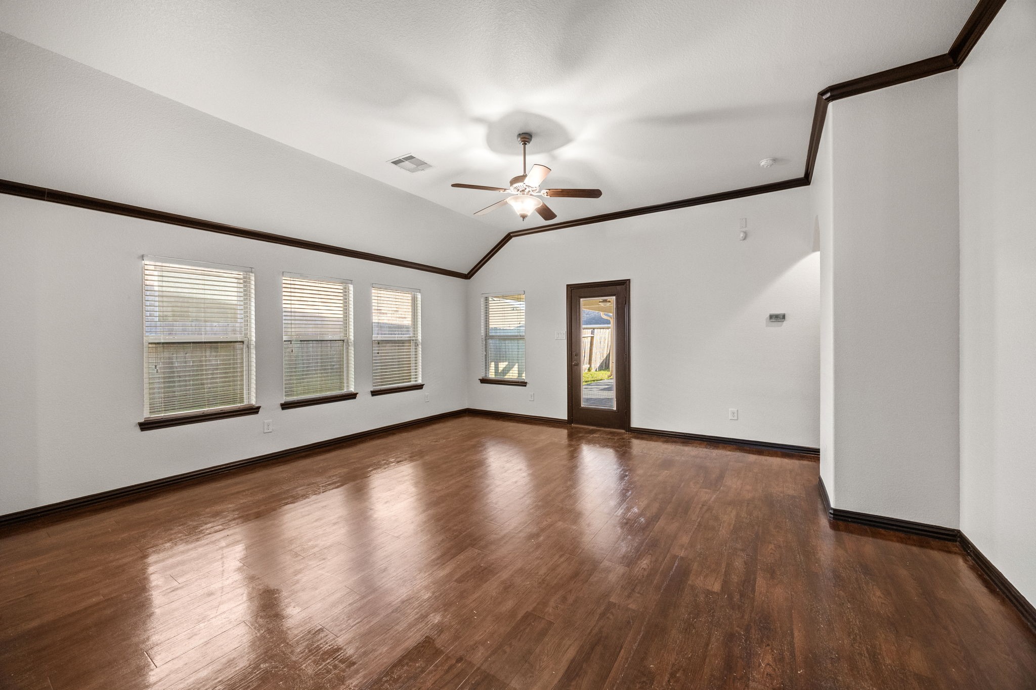 4342 Ambrosia Lane Baytown, TX 77521 - Photo 14 of 34 a view of an empty room with wooden floor and a window