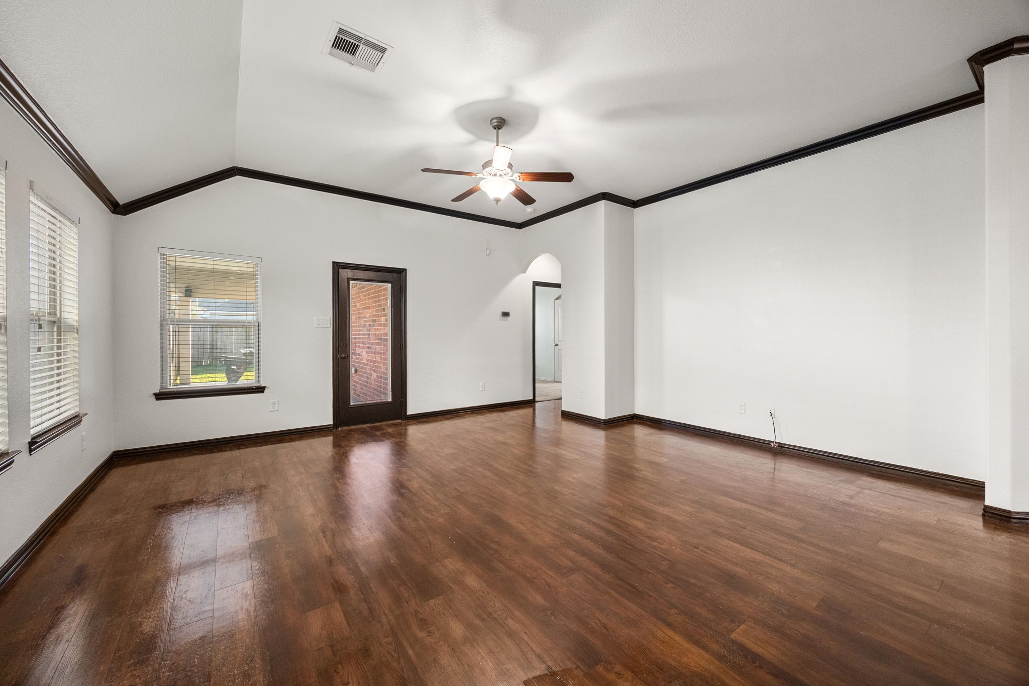 4342 Ambrosia Lane Baytown, TX 77521 - Photo 15 of 34 a view of an empty room with wooden floor and a ceiling fan