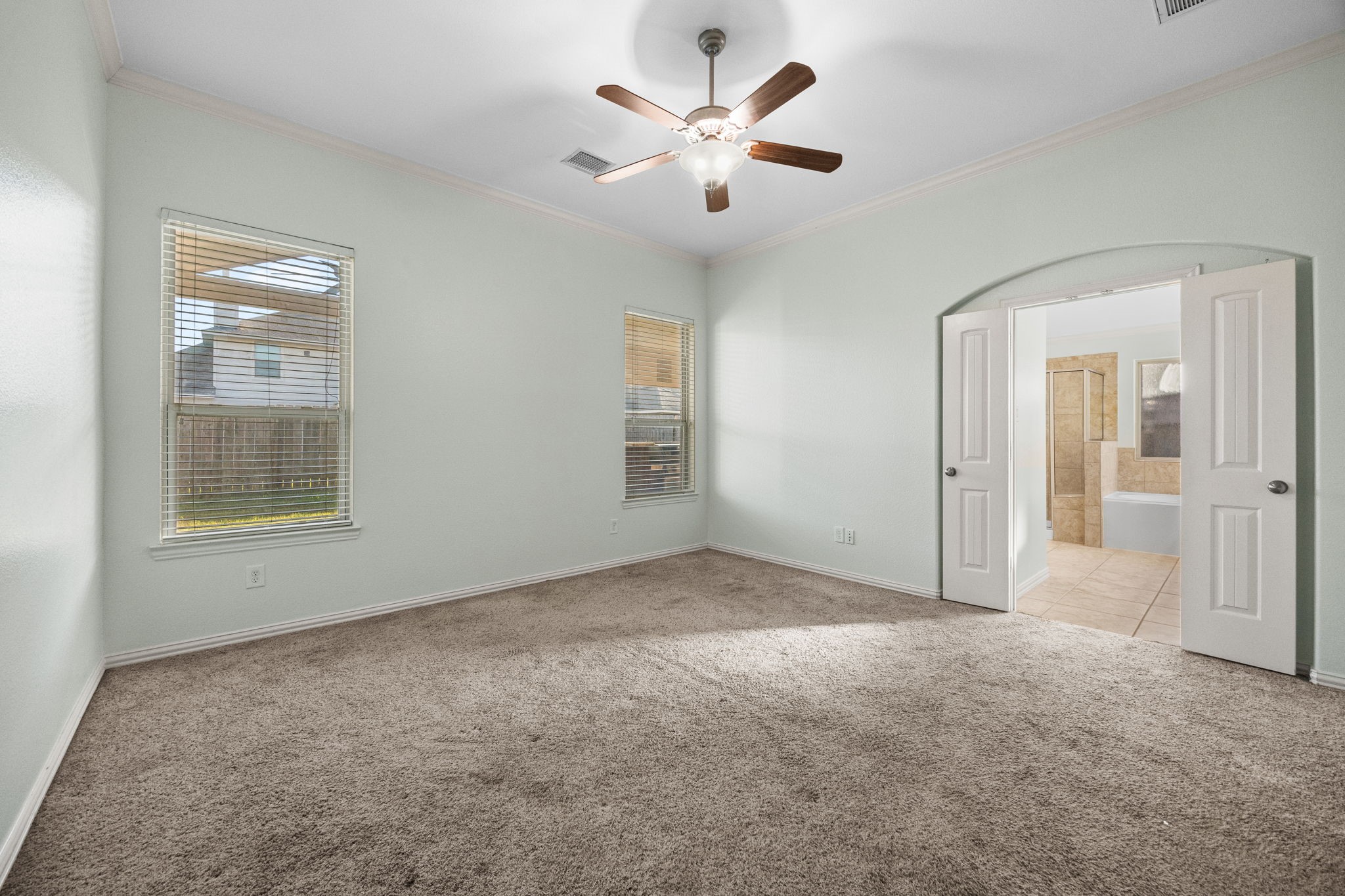 4342 Ambrosia Lane Baytown, TX 77521 - Photo 18 of 34 an empty room with windows and fan