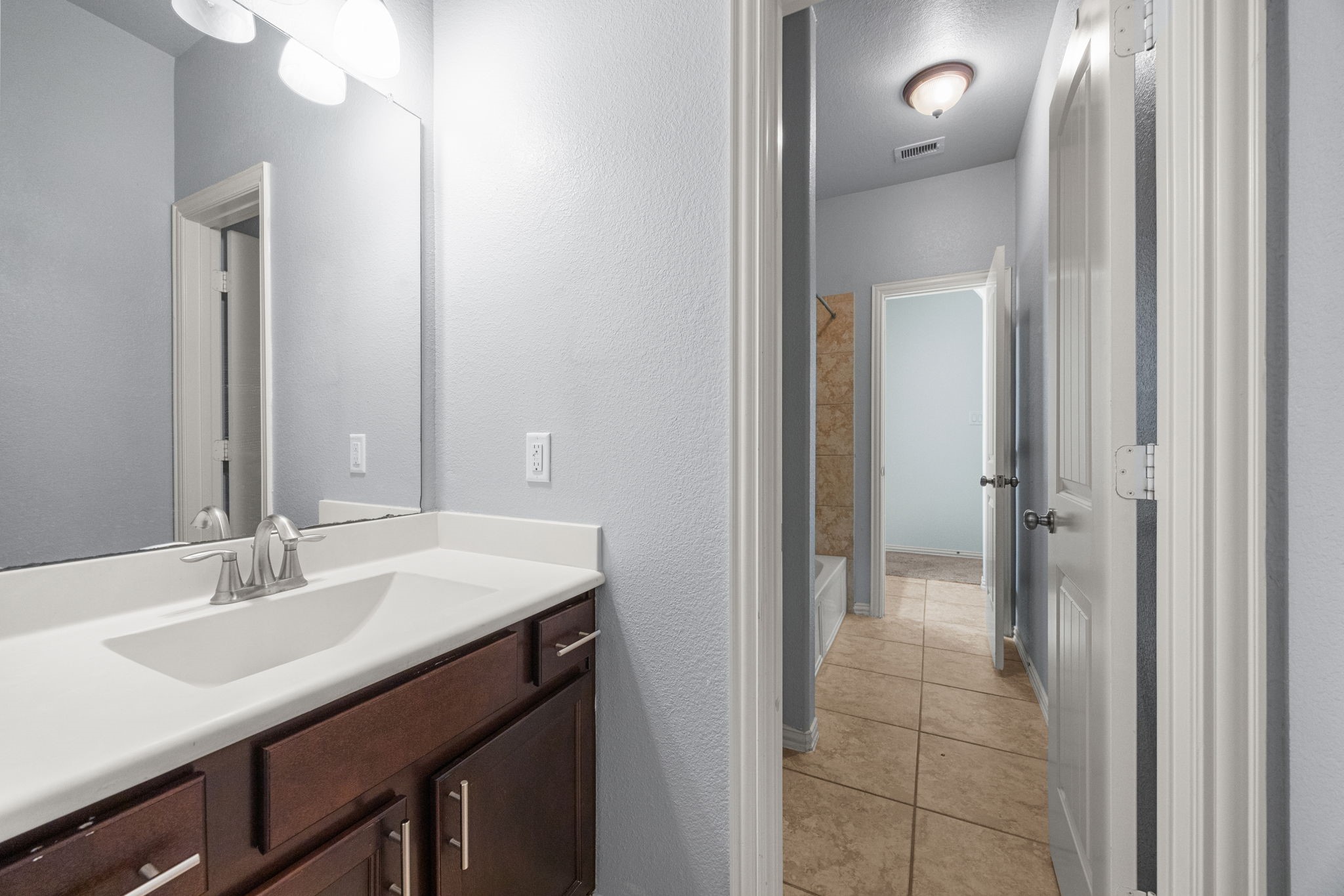 4342 Ambrosia Lane Baytown, TX 77521 - Photo 26 of 34 a bathroom with a sink vanity and a mirror
