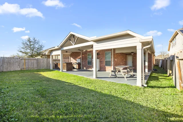a view of a house with backyard porch and sitting area