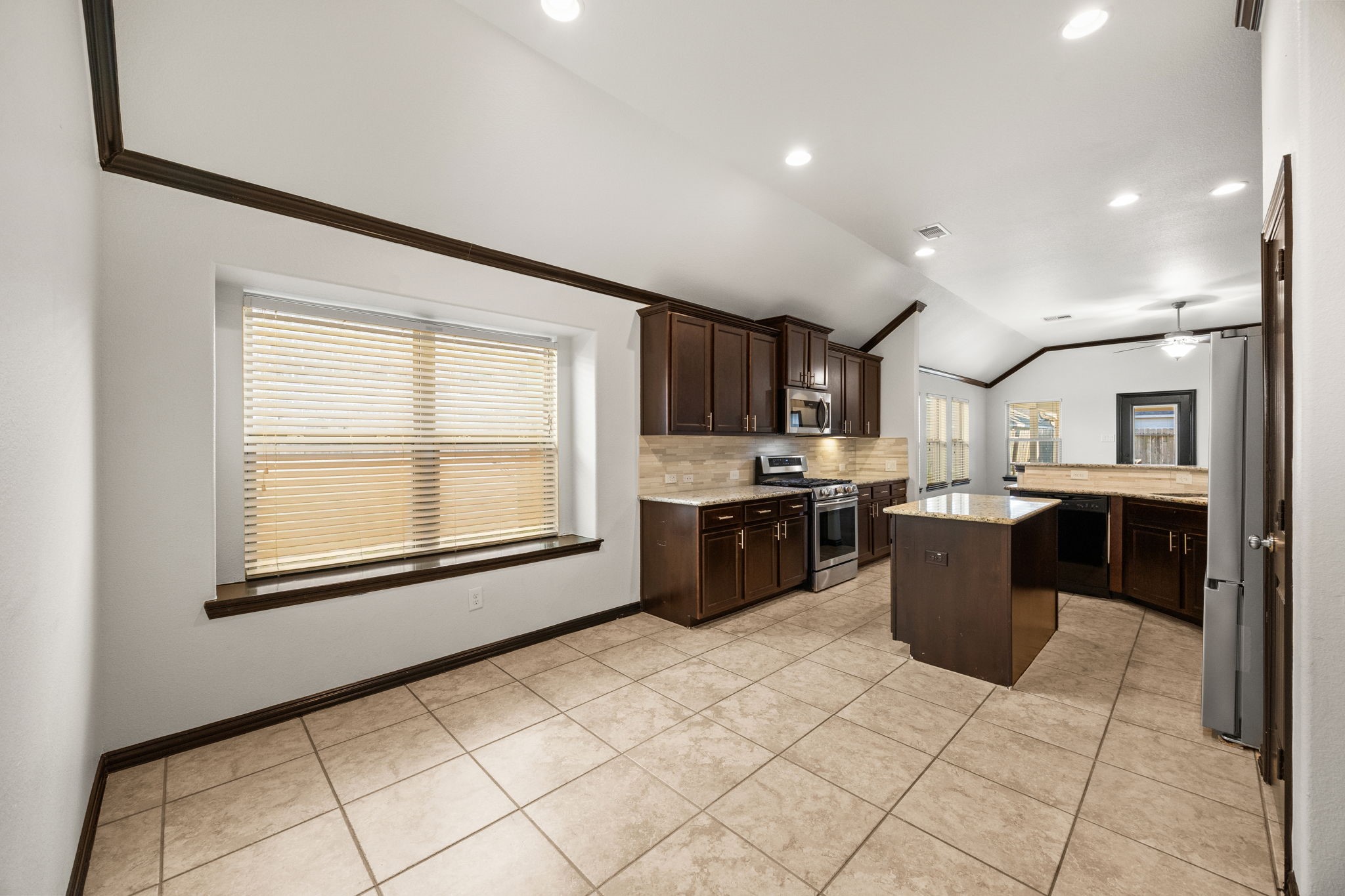 4342 Ambrosia Lane Baytown, TX 77521 - Photo 6 of 34 a large white kitchen with a large window