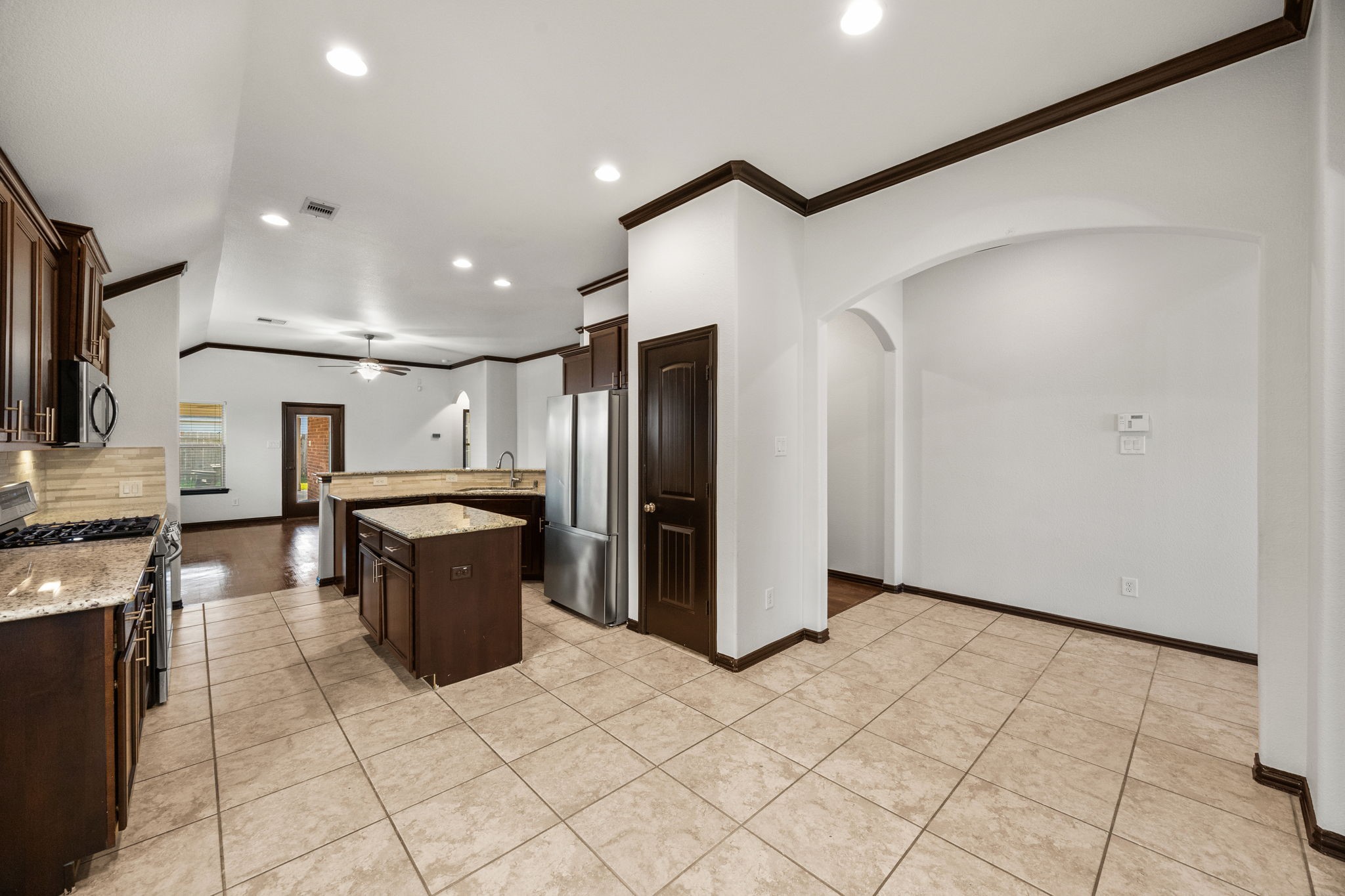 4342 Ambrosia Lane Baytown, TX 77521 - Photo 8 of 34 a kitchen with stainless steel appliances kitchen island granite countertop a refrigerator and a stove top oven
