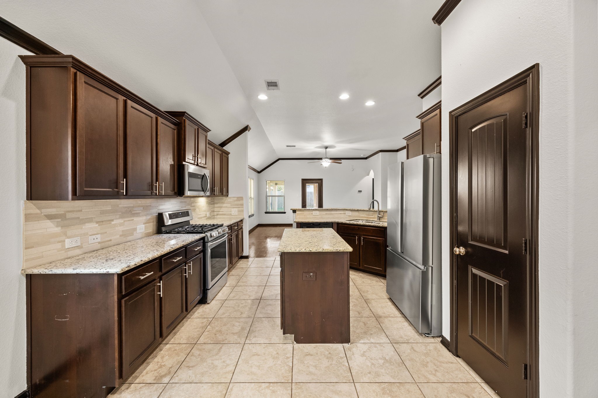4342 Ambrosia Lane Baytown, TX 77521 - Photo 9 of 34 a kitchen with stainless steel appliances granite countertop a refrigerator a sink and dishwasher