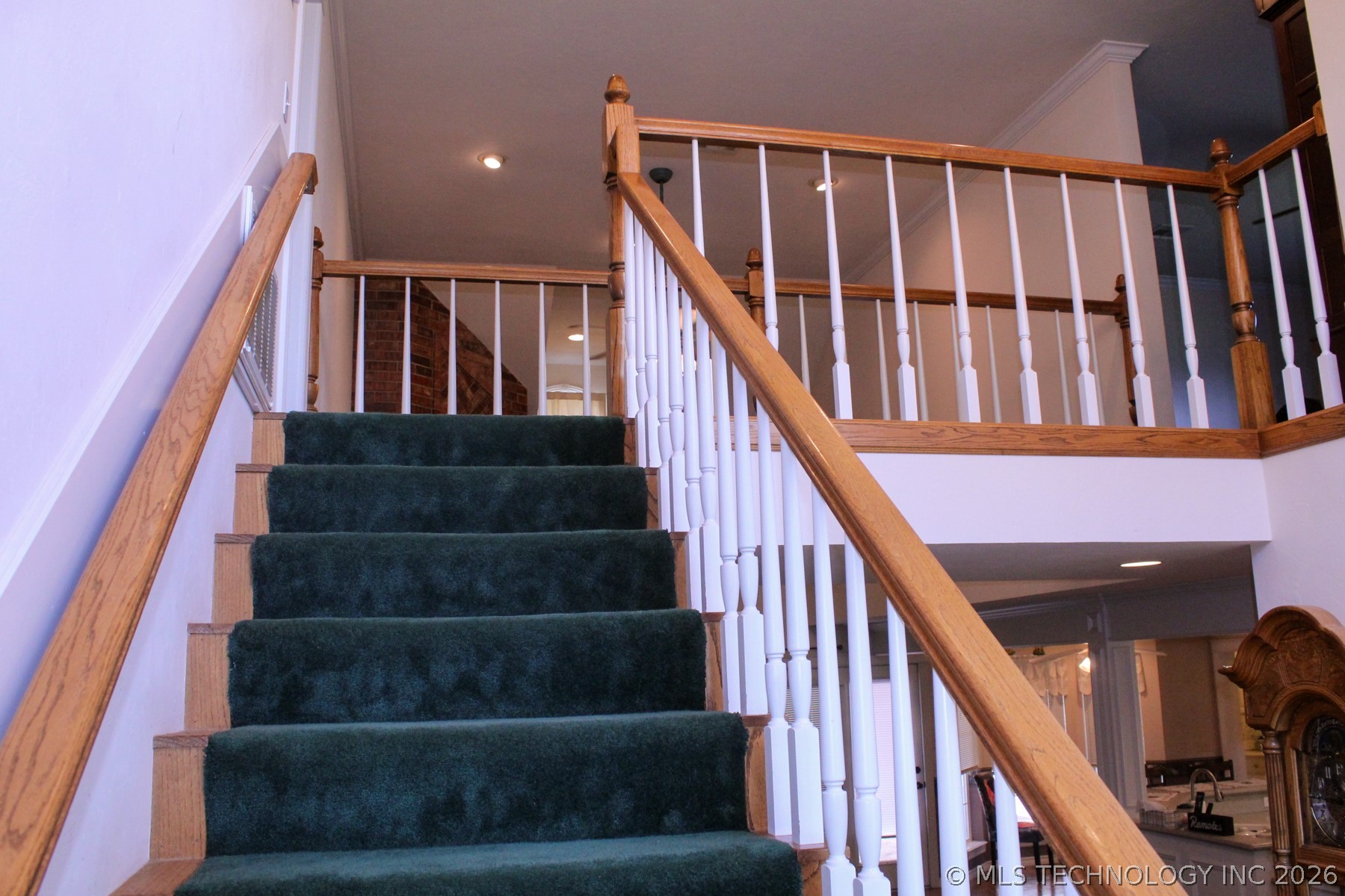 13248 North 3540th Road Maud, OK 74854 - Photo 66 of 98 Staircase featuring dark green carpeted treads and natural wood-finish risers