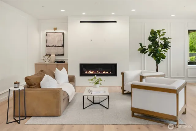 a living room with furniture and a potted plant