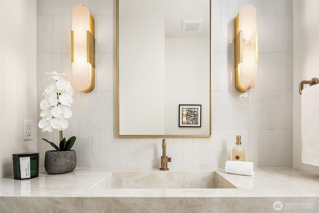 a bathroom with a tub and a mirror