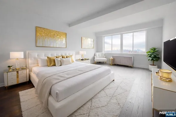 a bedroom with a bed couch and window