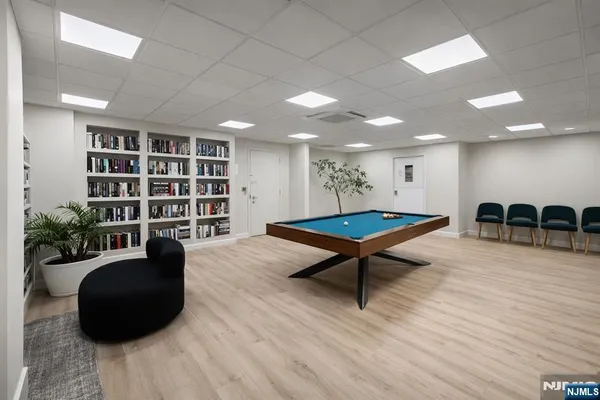 a living room with furniture and a book shelf