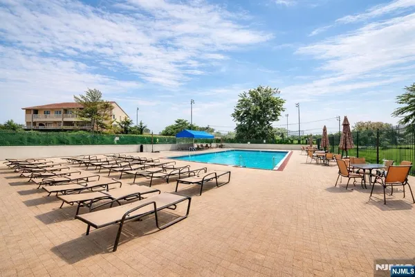 an outdoor space with swimming pool and furniture