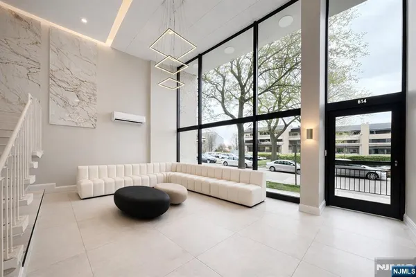 a living room with furniture and large windows