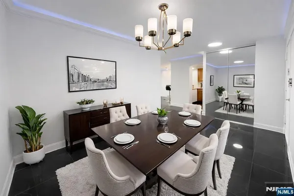 a view of a dining room with furniture and a chandelier