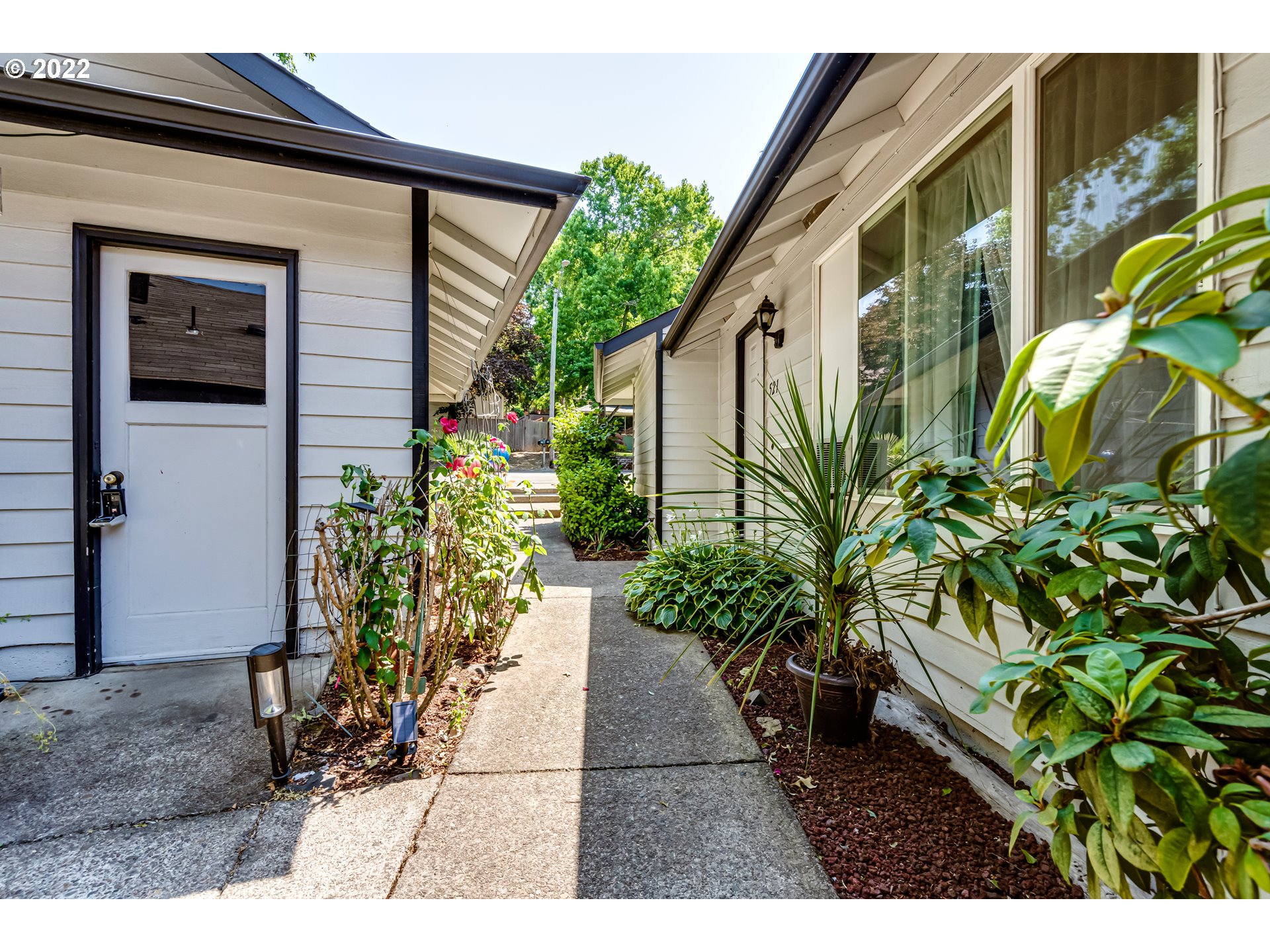 523 Janus Street Springfield, OR 97477 - Photo 24 of 27 a backyard of a house with flower plants