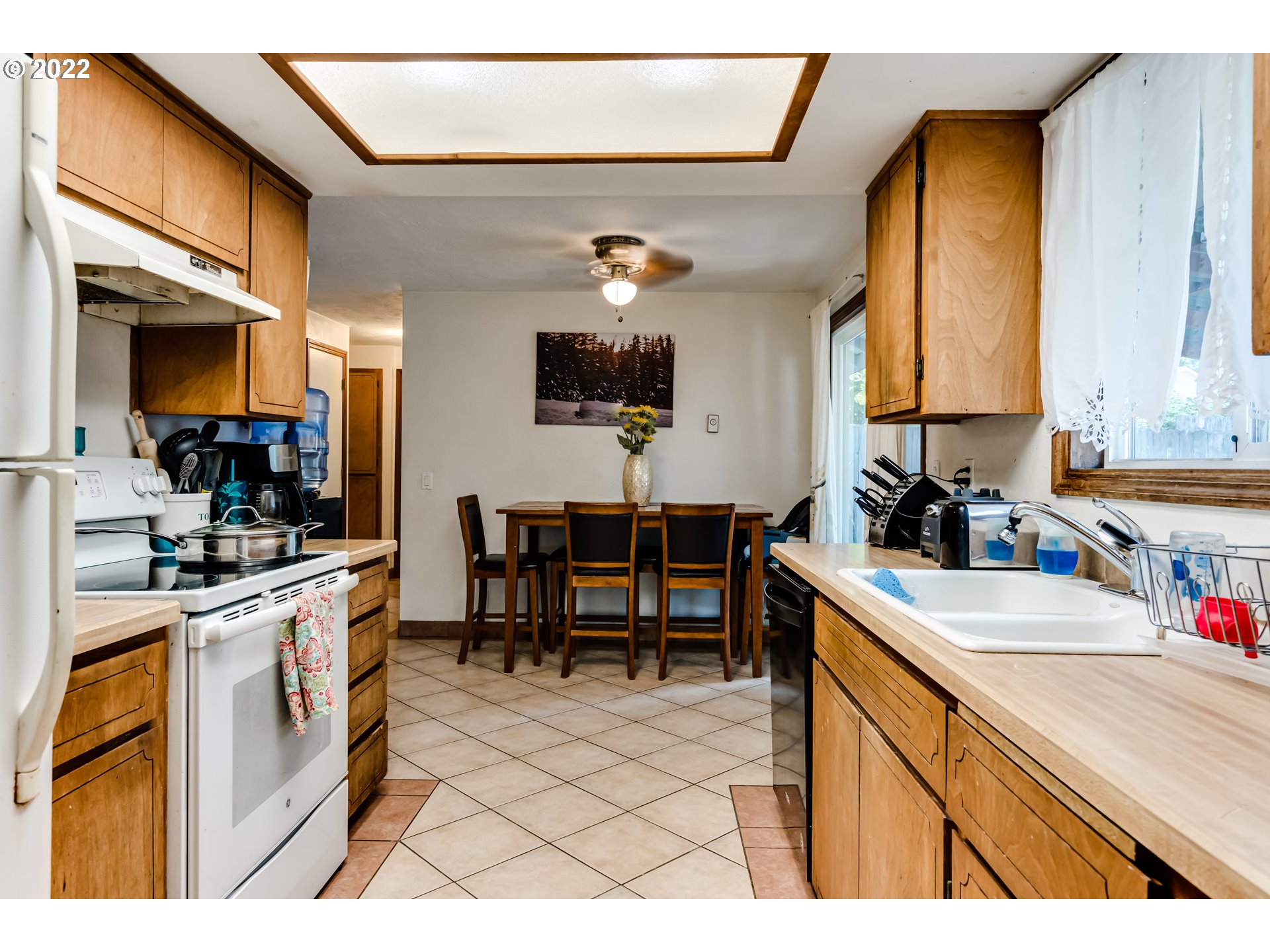 523 Janus Street Springfield, OR 97477 - Photo 3 of 27 a kitchen with a sink cabinets and window
