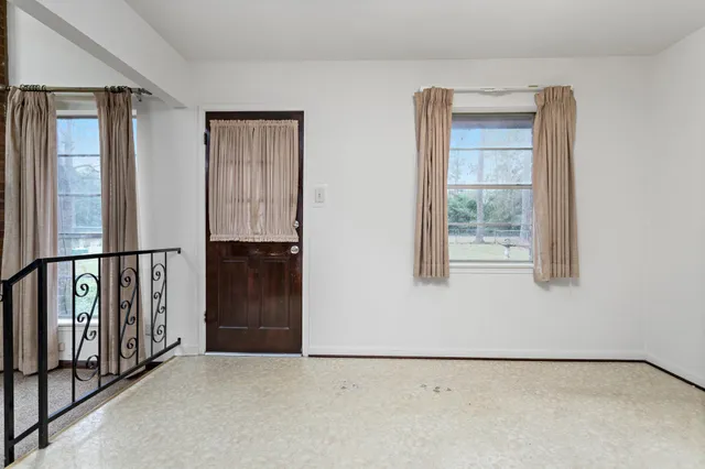 a kitchen with stainless steel appliances kitchen island granite countertop a stove refrigerator and cabinets