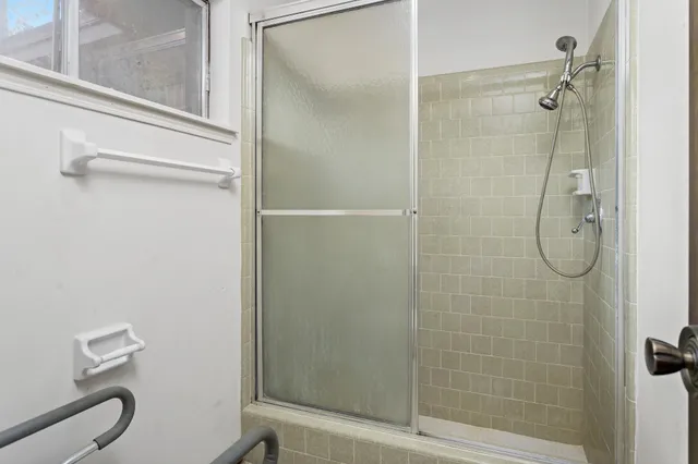 an empty room with a ceiling fan and a window