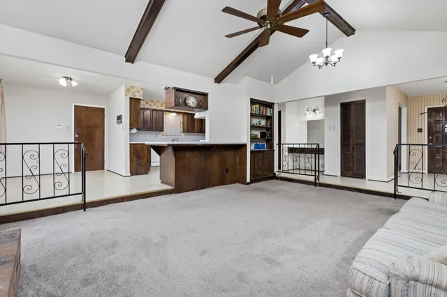 a view of a livingroom with furniture and staircase