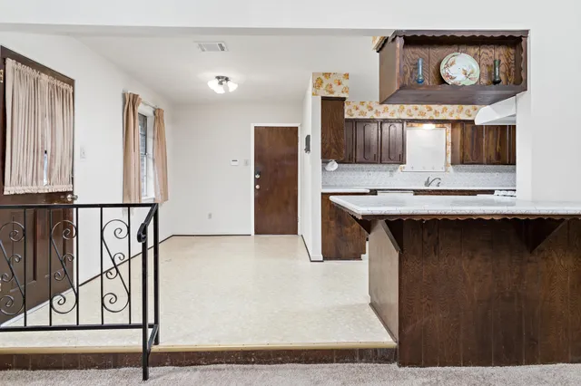 an entryway with a fireplace and windows