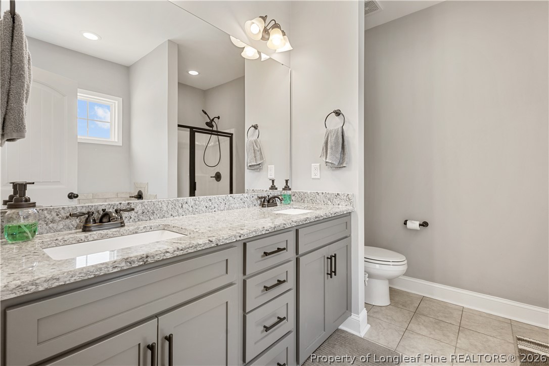 137 Minter School Road Sanford, NC 27332 - Photo 20 of 50 a bathroom with a granite countertop sink and a mirror