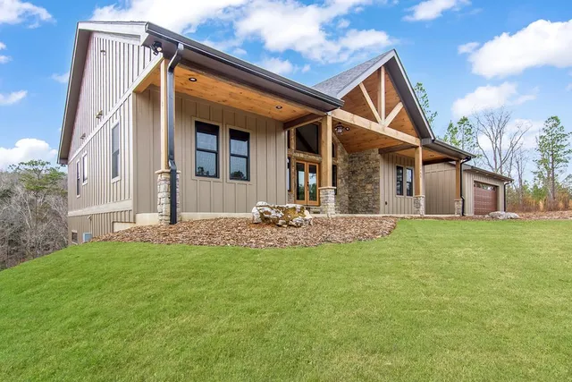 a view of a house with a yard and pathway