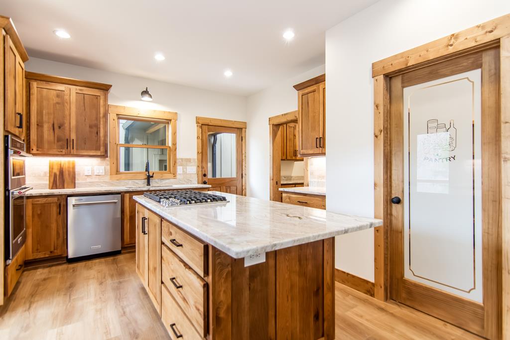 2468 Twisted Oak Road Talking Rock, GA 30175 - Photo 12 of 67 a kitchen with a stove a sink and a refrigerator