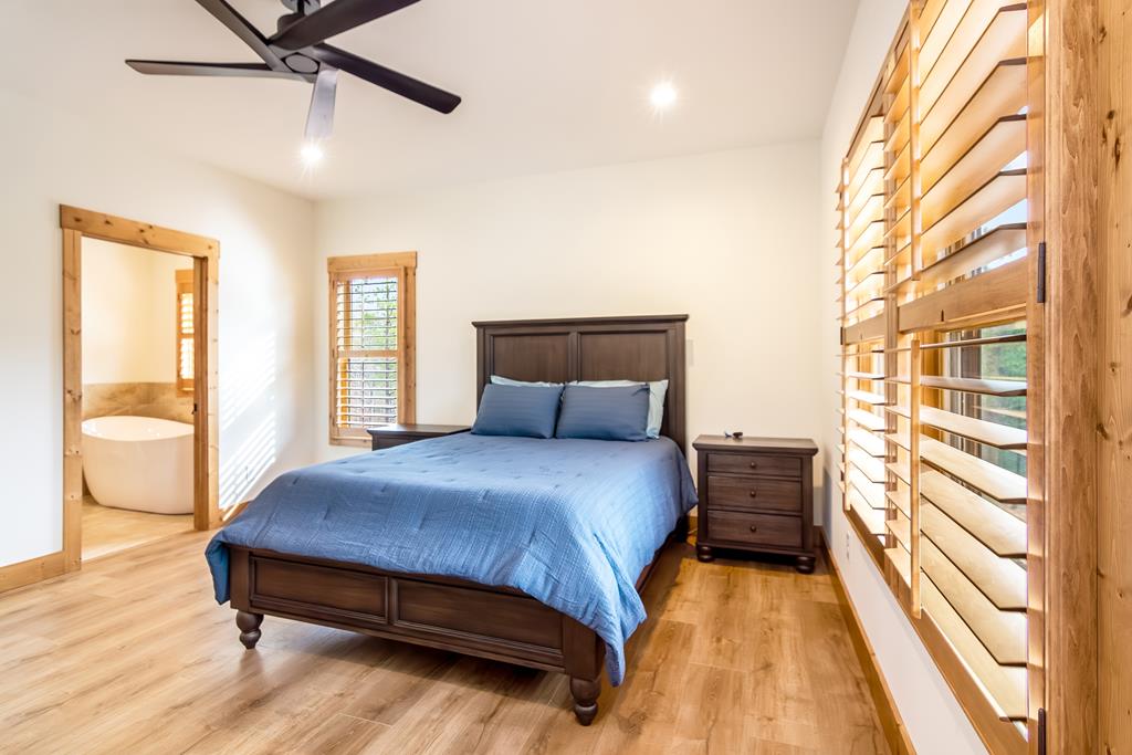 2468 Twisted Oak Road Talking Rock, GA 30175 - Photo 17 of 67 a bedroom with a bed and wooden floor