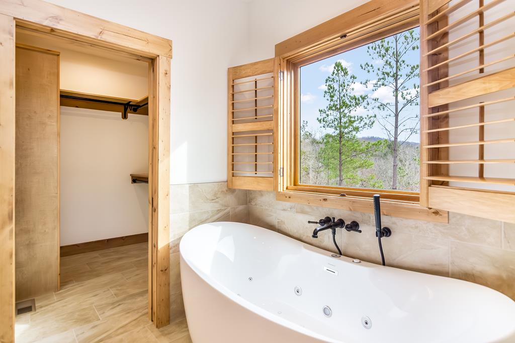 2468 Twisted Oak Road Talking Rock, GA 30175 - Photo 21 of 67 a bathroom with a tub and a window