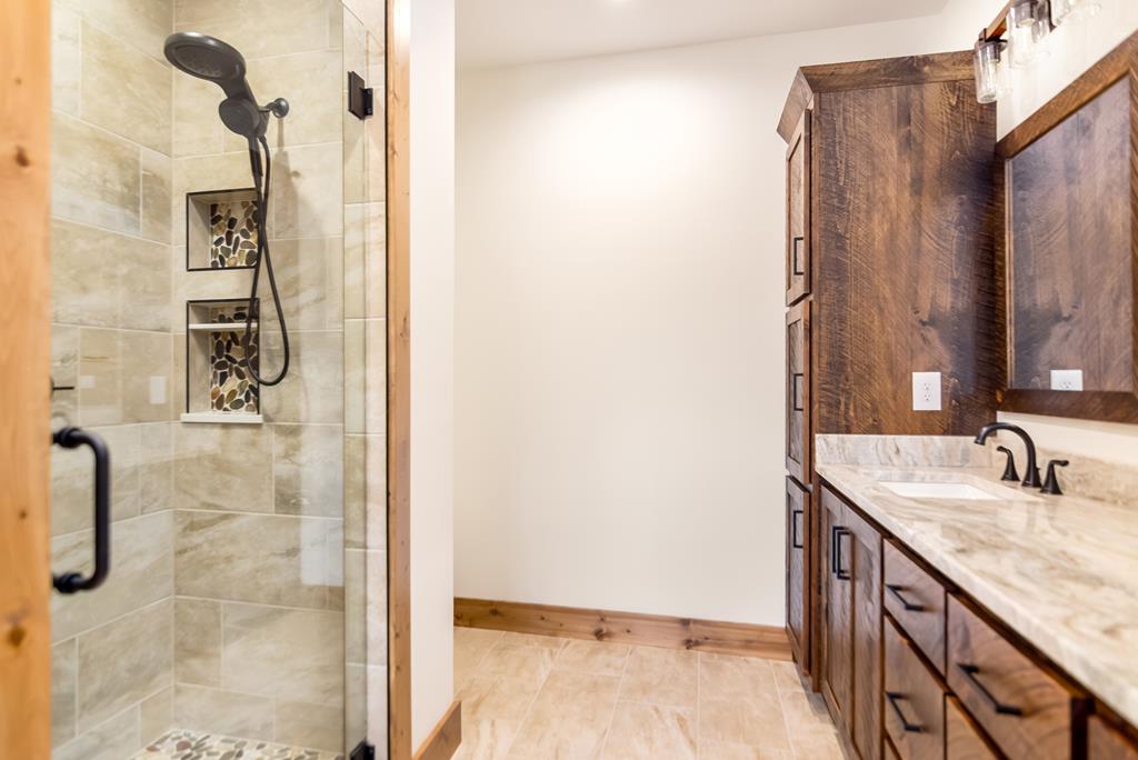 2468 Twisted Oak Road Talking Rock, GA 30175 - Photo 25 of 67 a bathroom with a granite countertop shower and a sink