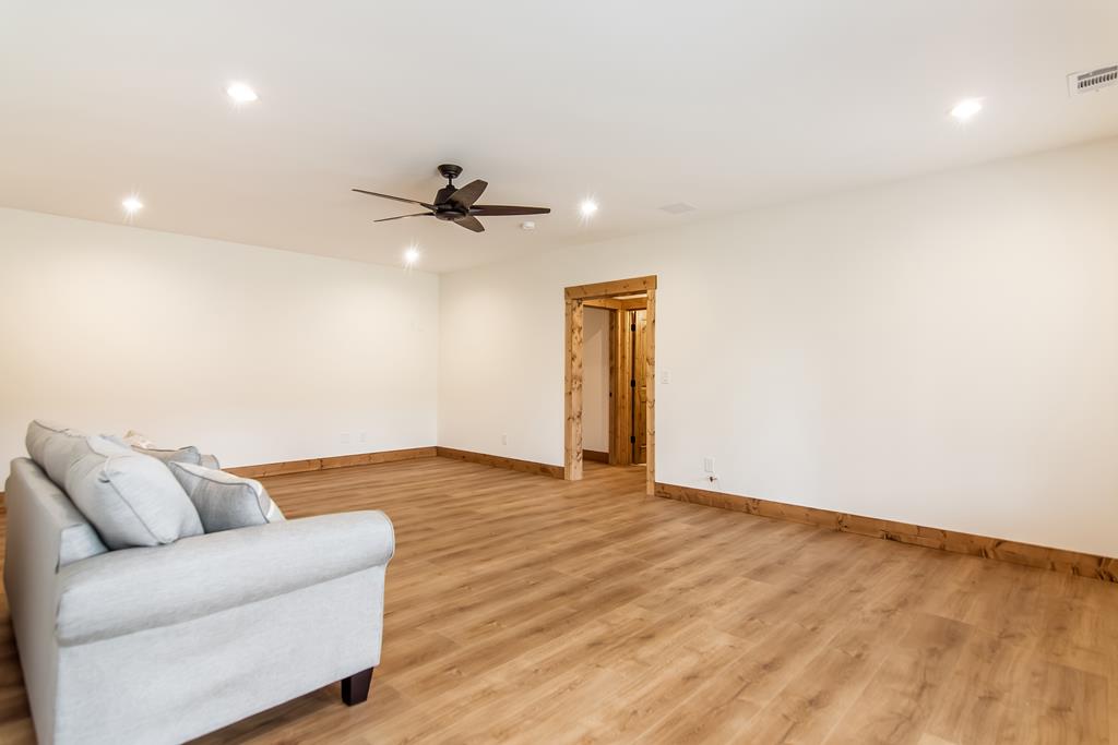 2468 Twisted Oak Road Talking Rock, GA 30175 - Photo 27 of 67 a view of livingroom with a ceiling fan and wooden floor