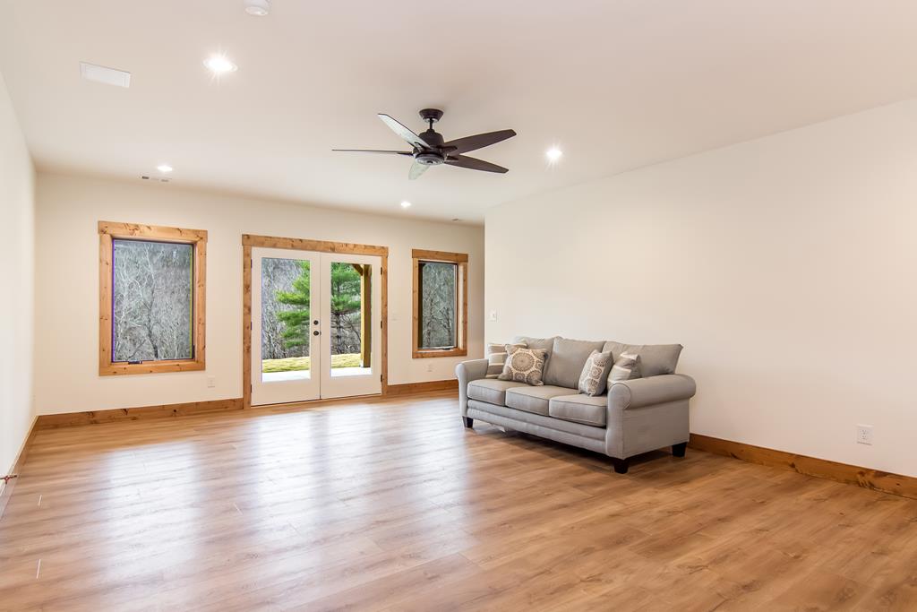 2468 Twisted Oak Road Talking Rock, GA 30175 - Photo 28 of 67 a living room with furniture and a large window