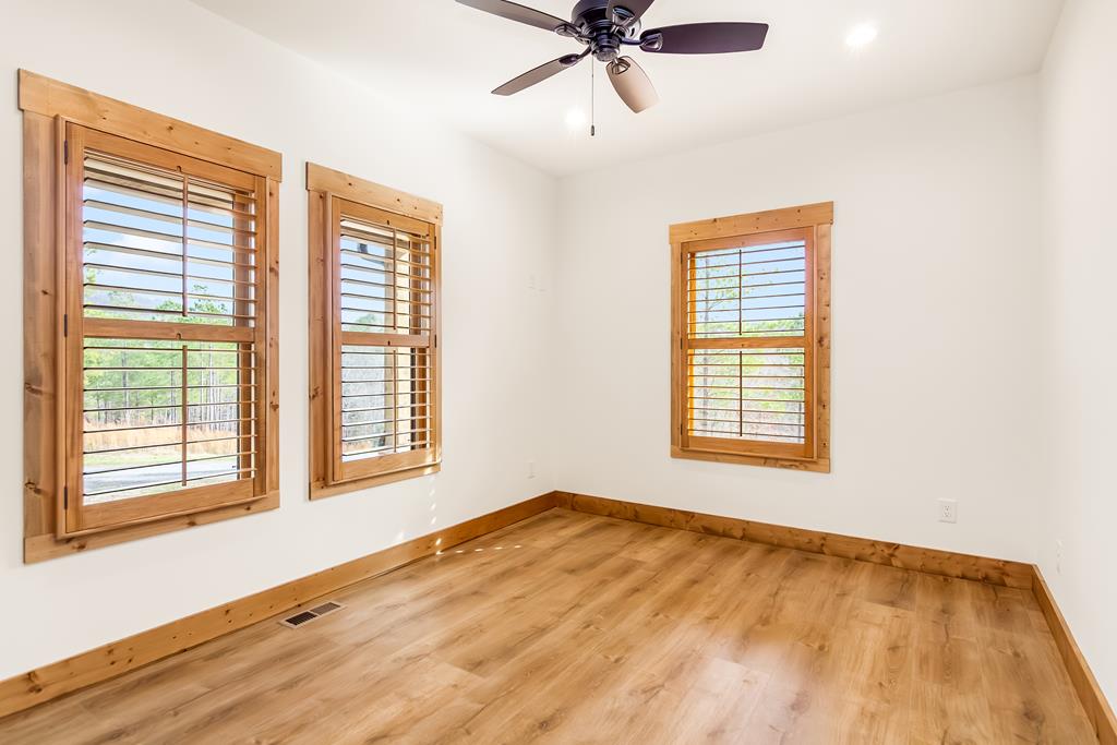 2468 Twisted Oak Road Talking Rock, GA 30175 - Photo 31 of 67 a view of an empty room with a window and wooden floor