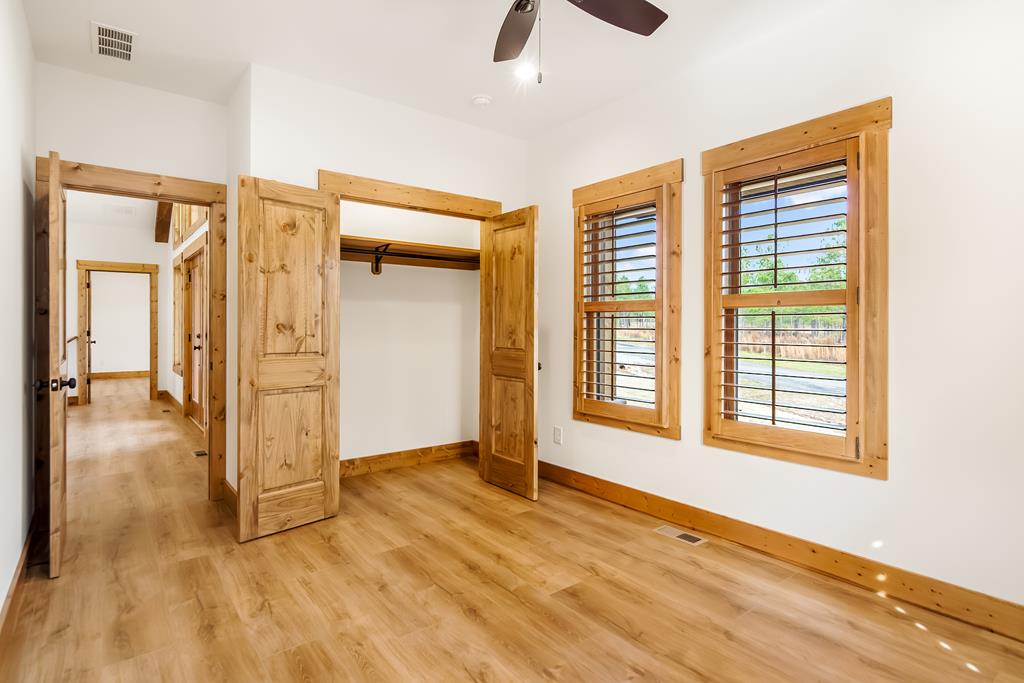 2468 Twisted Oak Road Talking Rock, GA 30175 - Photo 32 of 67 a view of an empty room with wooden floor and a window