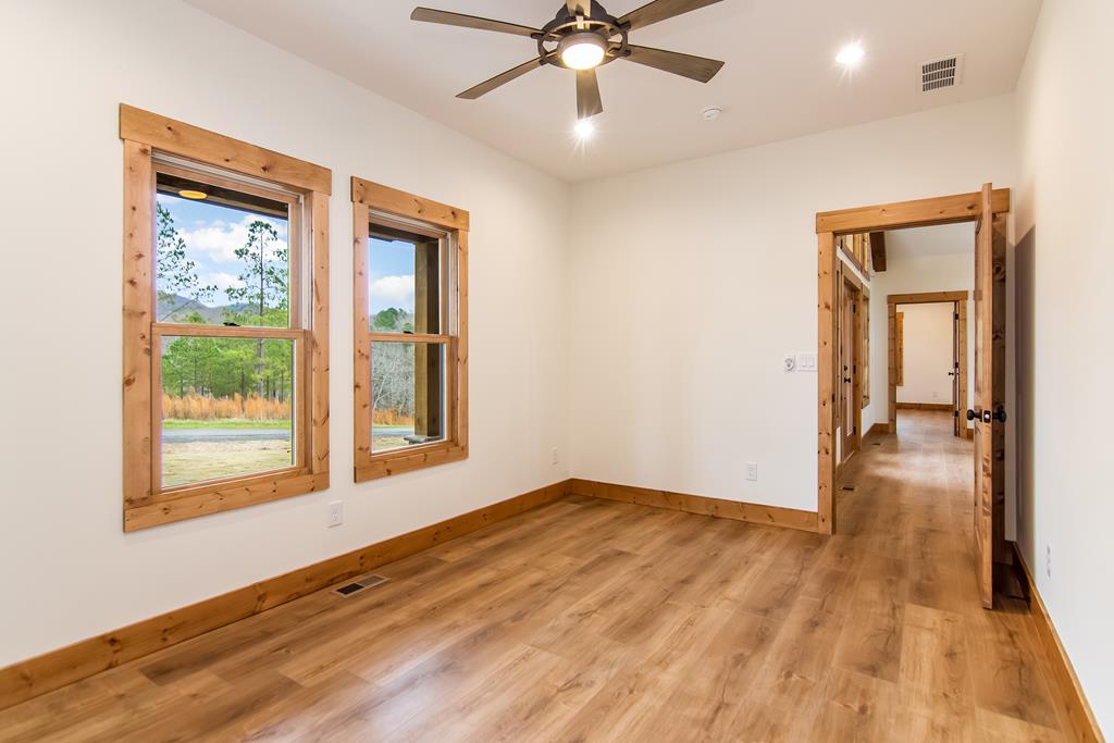 2468 Twisted Oak Road Talking Rock, GA 30175 - Photo 34 of 67 a view of an empty room with wooden floor and a window