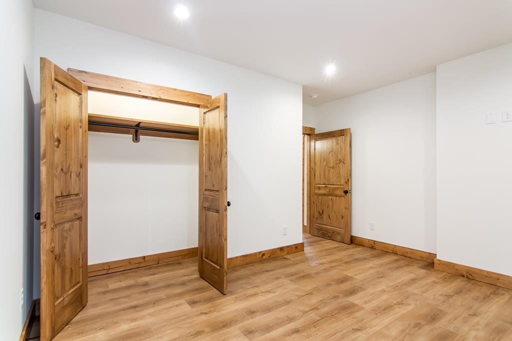 2468 Twisted Oak Road Talking Rock, GA 30175 - Photo 35 of 67 an empty room with wooden floor and a bathroom