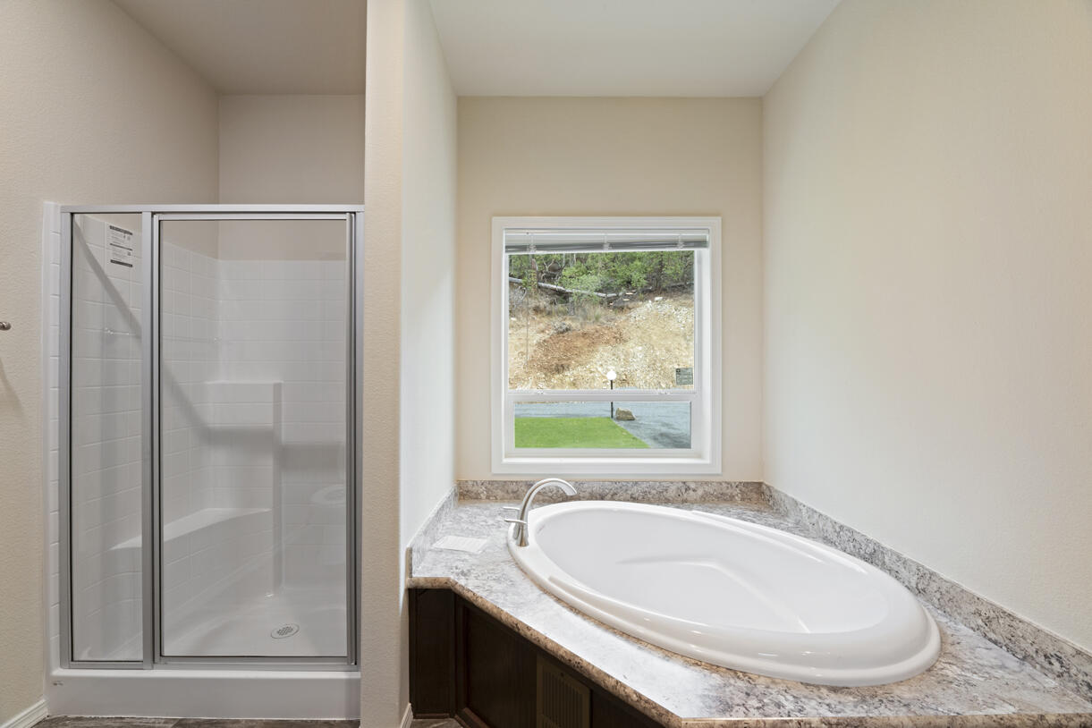 5572 Jumpoff Joe Creek Road Grants Pass, OR 97526 - Photo 13 of 38 a bathroom with a granite countertop sink and a mirror