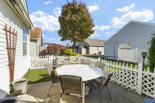 a view of a patio with a table and chairs