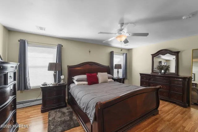 a bedroom with a bed and a dresser with mirror