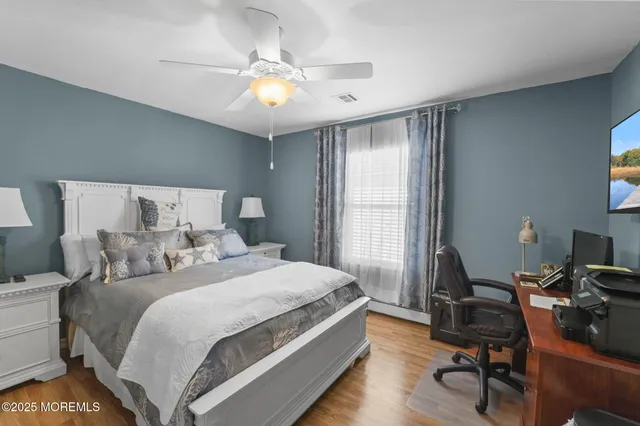 a bedroom with a bed and a desk