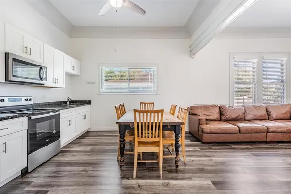 a living room with furniture a dining table and with fireplace