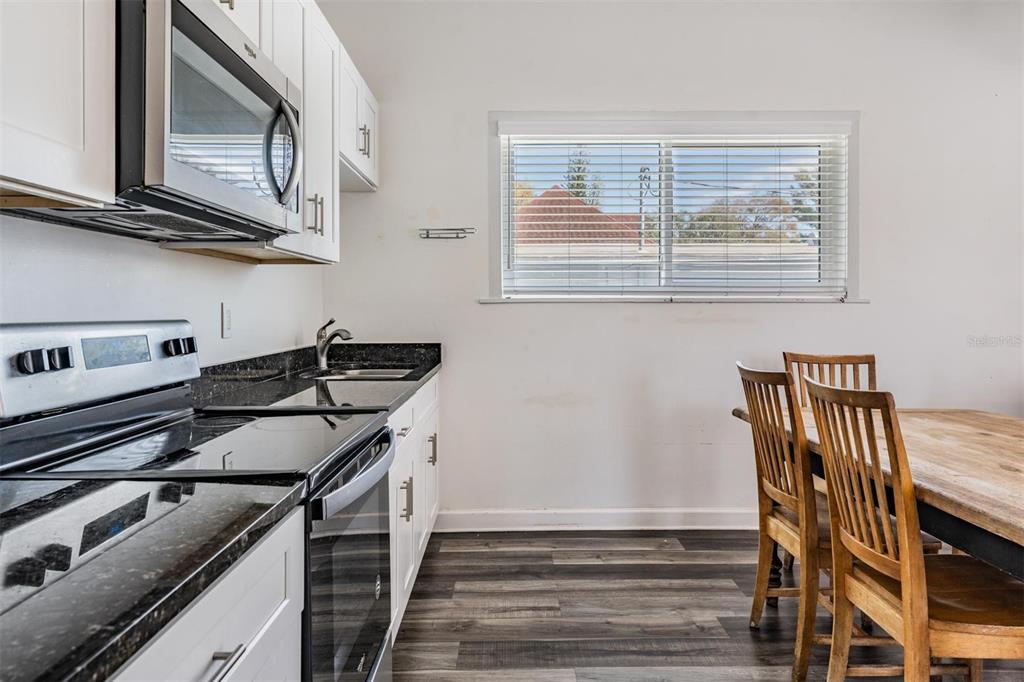 2319 West Aileen Street Tampa, FL 33607 - Photo 19 of 26 a kitchen with wooden cabinets and a stove top oven