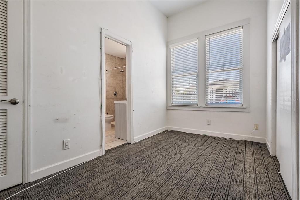 2319 West Aileen Street Tampa, FL 33607 - Photo 24 of 26 an empty room with wooden floor and windows