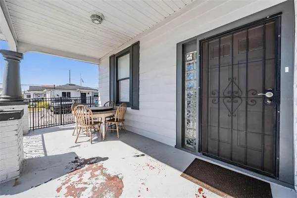 a living room with stainless steel appliances kitchen island granite countertop furniture and a rug