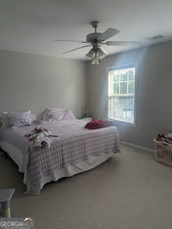 a bedroom with a bed and window